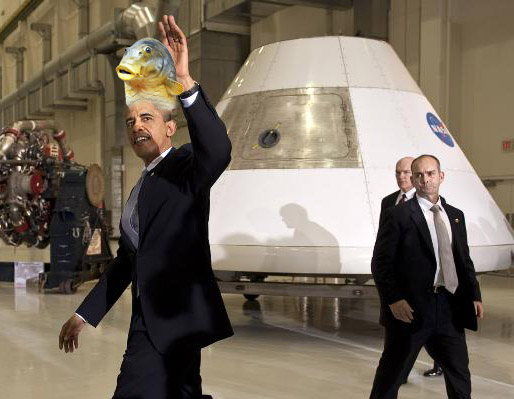 President Obama, wearing a kipper (why not), walks past props from the moon landing that was totally a hoax to perpetuate the myth of a round Earth. From a NASA image, with help from @darth.