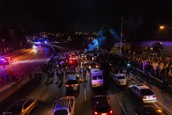 Protesters shut down interstate 580 in Oakland, chanting “Black lives matter” and “hands up, don’t shoot”