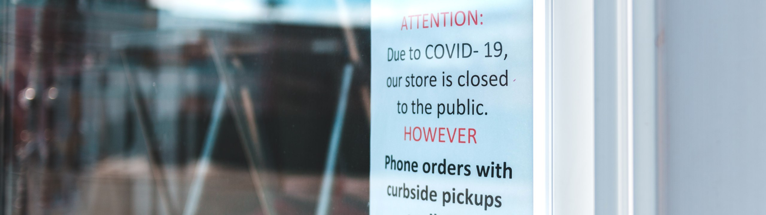 COVID-19 closure sign in storefront window